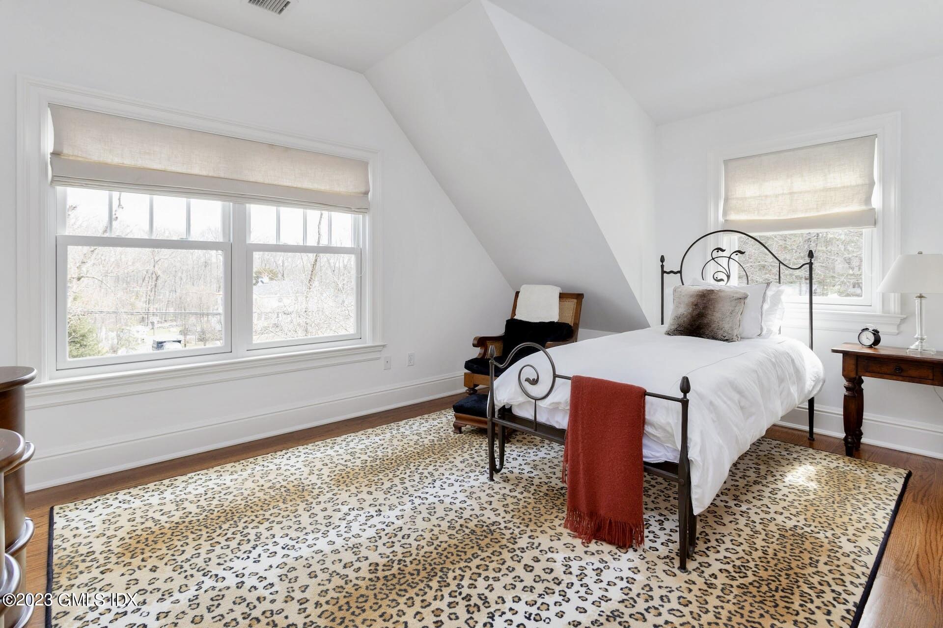 154 Cognewaugh Road Cos Cob, CT 06807 - Photo 25 of 46 a bed sitting in a bedroom next to a window