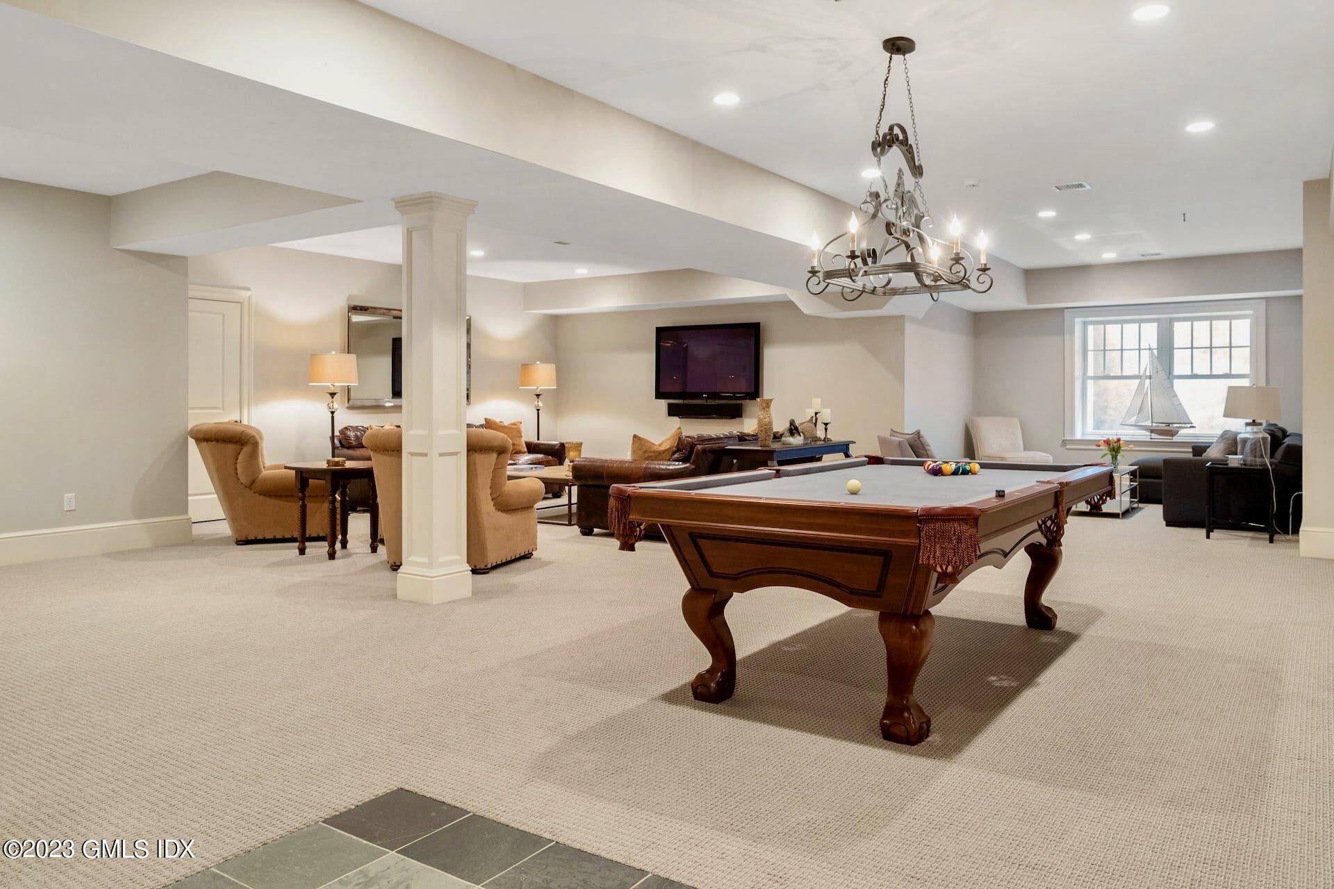 154 Cognewaugh Road Cos Cob, CT 06807 - Photo 31 of 46 a living room with furniture a piano and a chandelier