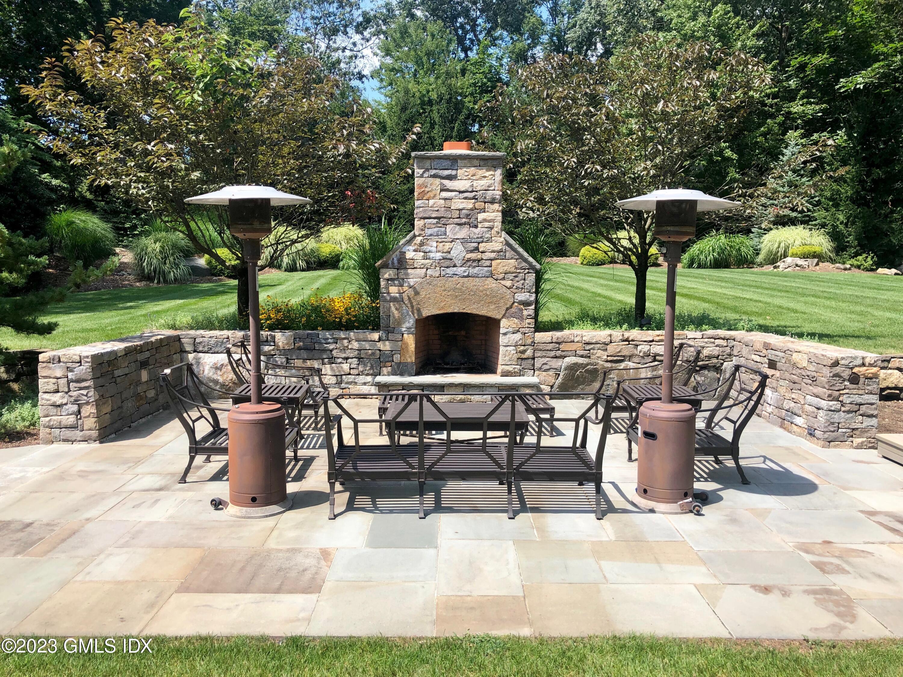 154 Cognewaugh Road Cos Cob, CT 06807 - Photo 36 of 46 a view of a chairs and table in backyard