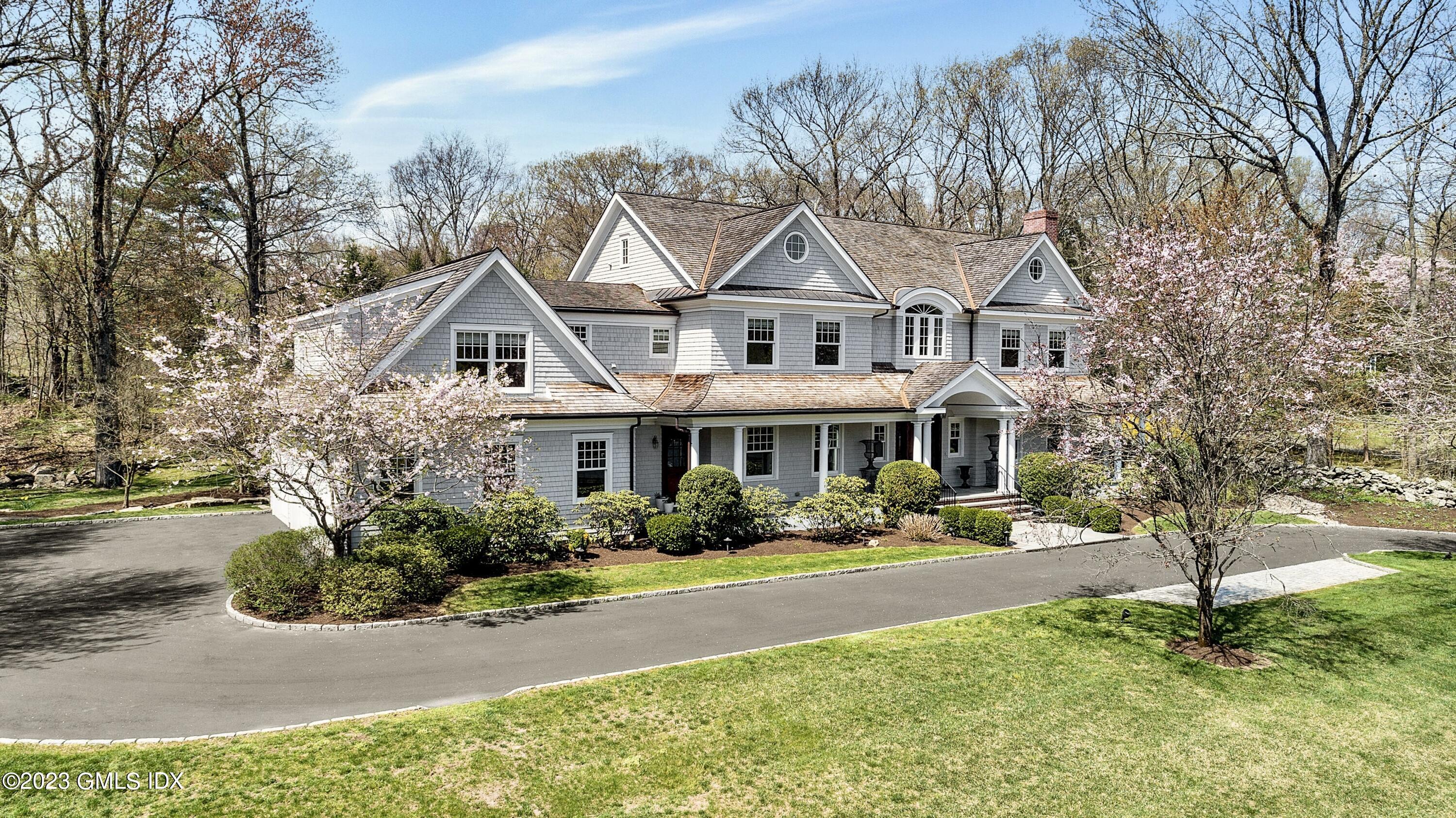 154 Cognewaugh Road Cos Cob, CT 06807 - Photo 42 of 46 a front view of a house with a yard