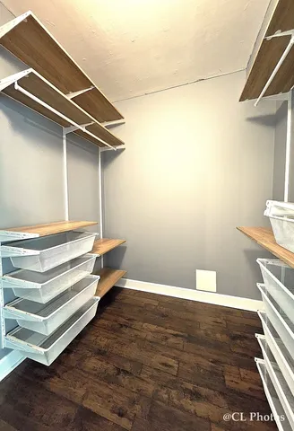 a view of a room with wooden floor and cabinet