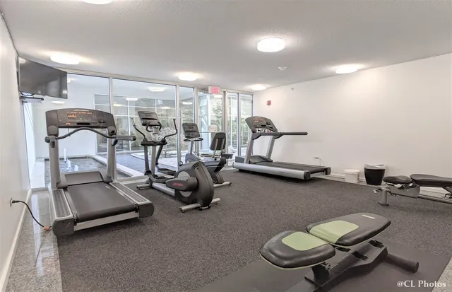 a dining room with furniture and a large window