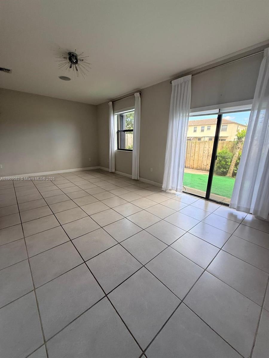 12715 Southwest 230th Terrace, Unit 1 Miami, FL 33170 - Photo 11 of 24 a view of an empty room with a window
