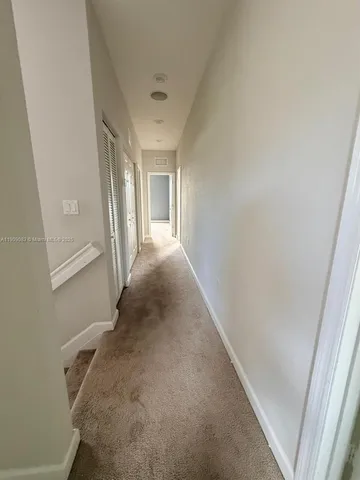 a view of a hallway to a bedroom