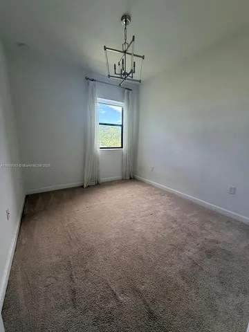 a view of room with window and ceiling fan