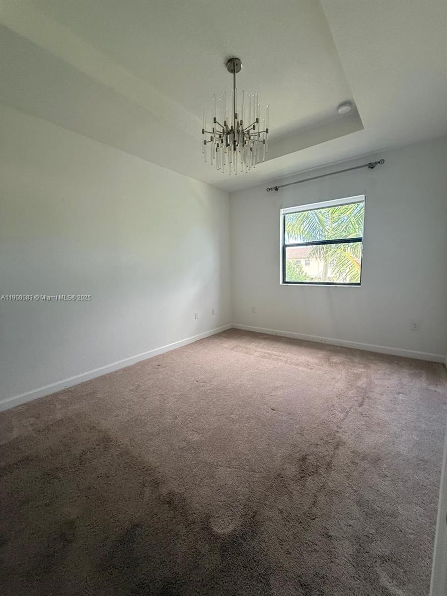 12715 Southwest 230th Terrace, Unit 1 Miami, FL 33170 - Photo 17 of 24 wooden floor in an empty room with a window