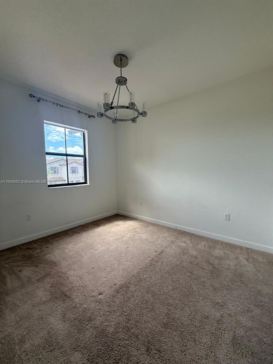 12715 Southwest 230th Terrace, Unit 1 Miami, FL 33170 - Photo 22 of 24 an empty room with a empty space and windows