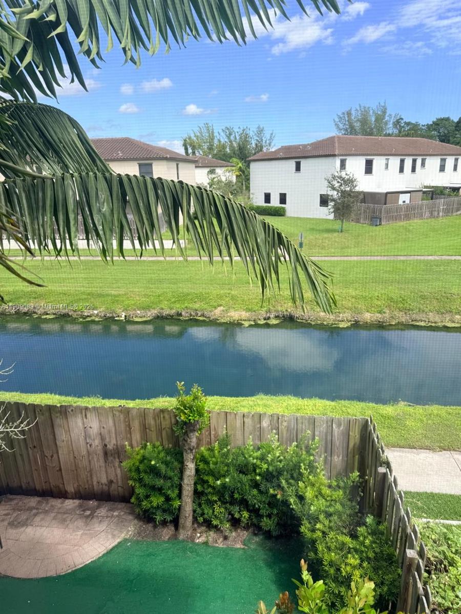 12715 Southwest 230th Terrace, Unit 1 Miami, FL 33170 - Photo 24 of 24 a view of a lake with a building in the background
