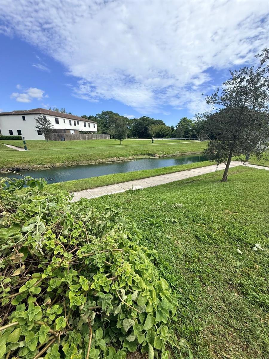 12715 Southwest 230th Terrace, Unit 1 Miami, FL 33170 - Photo 9 of 24 a view of a golf course with a lake