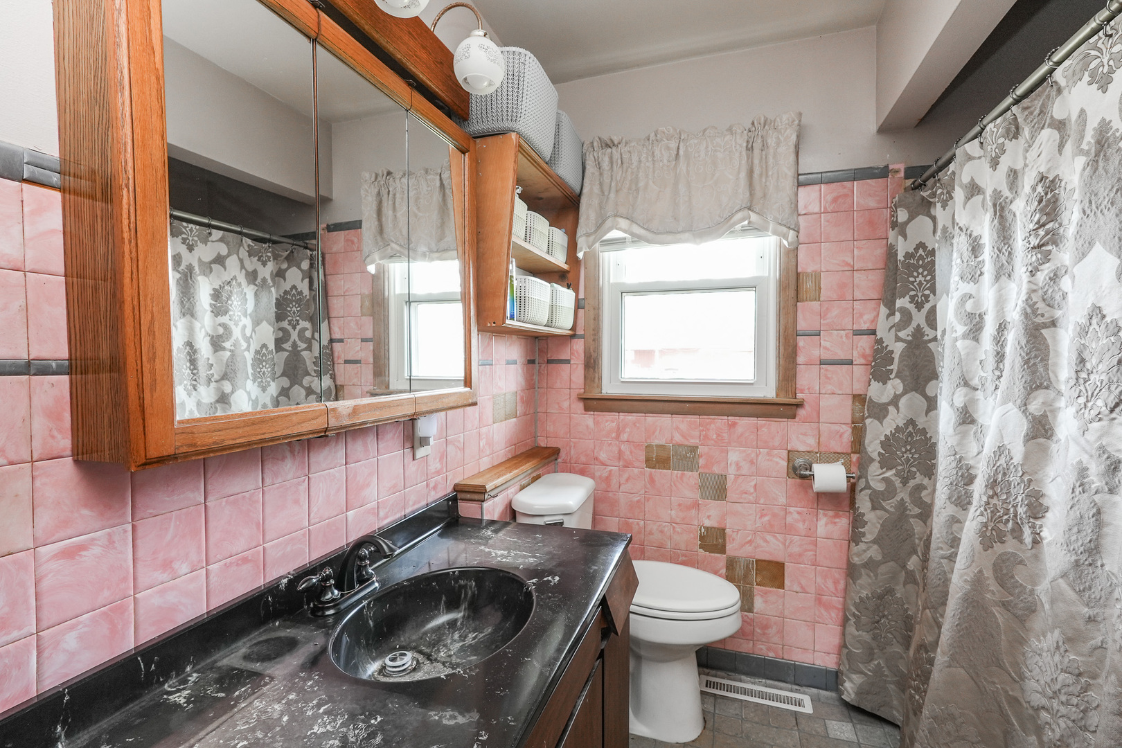 304 Ashley Avenue Bourbonnais, IL 60914 - Photo 12 of 18 a bathroom with a sink a toilet and a window