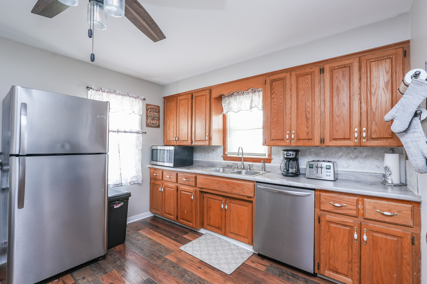 304 Ashley Avenue Bourbonnais, IL 60914 - Photo 7 of 18 a kitchen with stainless steel appliances granite countertop a refrigerator a sink a stove cabinets and wooden floor