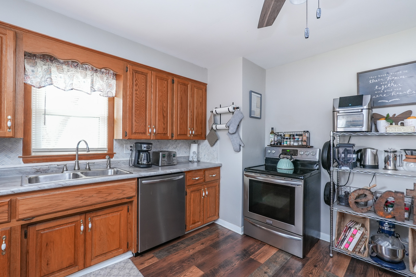304 Ashley Avenue Bourbonnais, IL 60914 - Photo 8 of 18 a kitchen with stainless steel appliances granite countertop a stove a sink dishwasher and a refrigerator with wooden cabinets