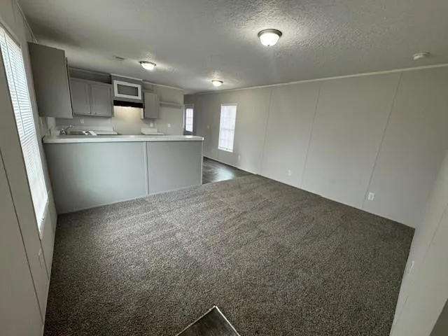 a view of kitchen cabinets and wooden floor