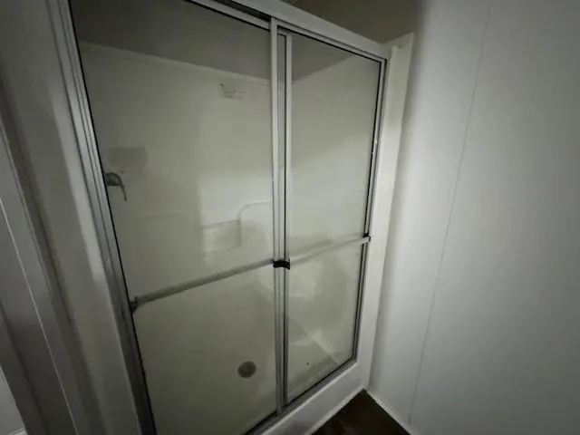 a bathroom with a glass shower door