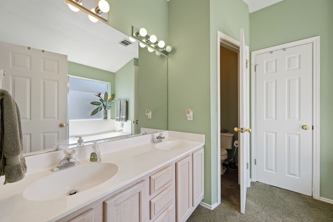 14505 Sandifer Street Austin, TX 78725 - Photo 14 of 28 a bathroom with a sink double vanity and a mirror