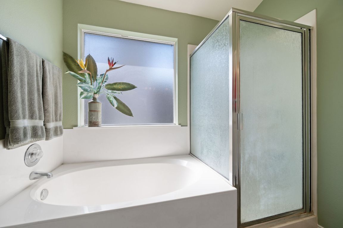 14505 Sandifer Street Austin, TX 78725 - Photo 15 of 28 a bathroom with a bathtub and a shower