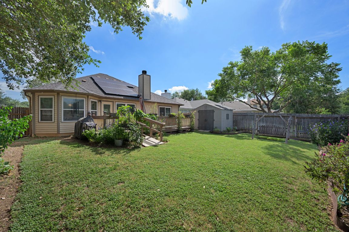 14505 Sandifer Street Austin, TX 78725 - Photo 24 of 28 a view of a house with a back yard