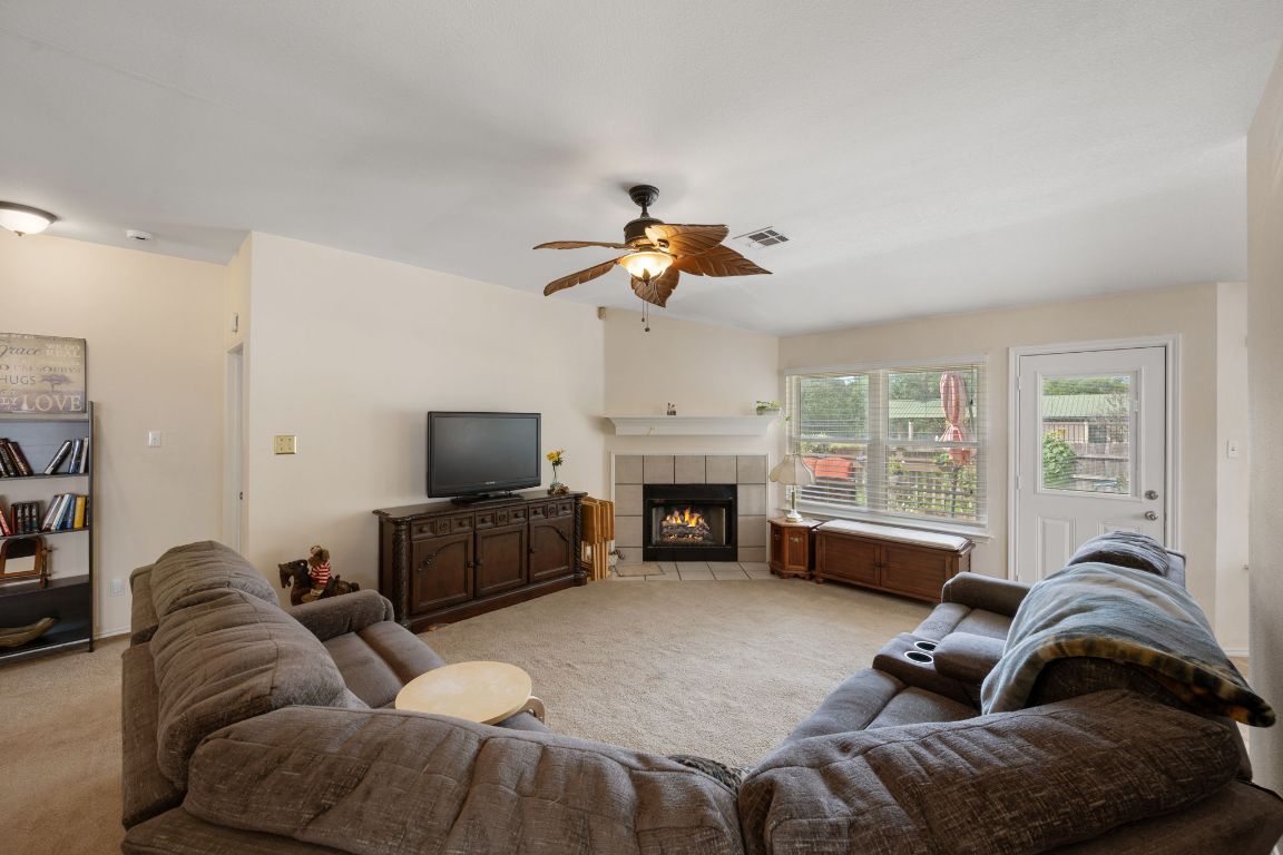 14505 Sandifer Street Austin, TX 78725 - Photo 3 of 28 a living room with furniture fireplace and flat screen tv