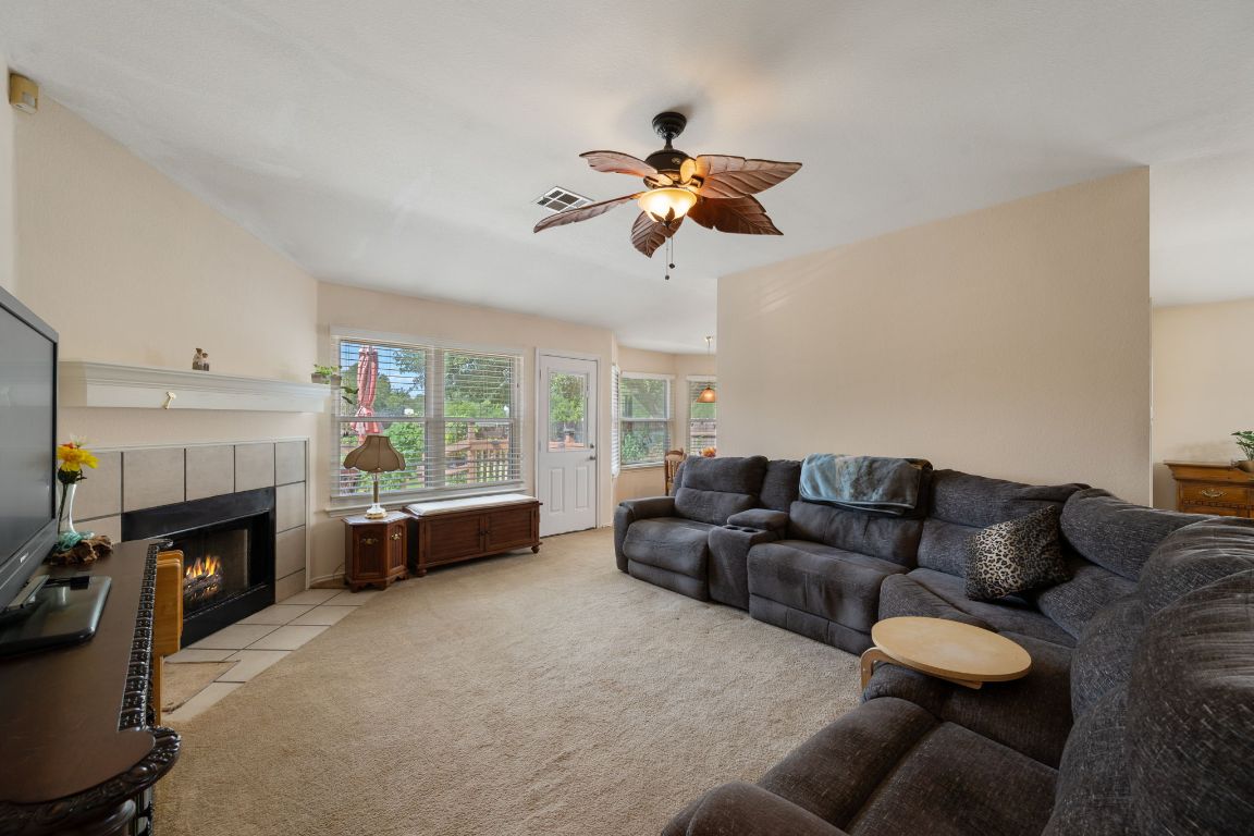 14505 Sandifer Street Austin, TX 78725 - Photo 4 of 28 a living room with furniture a fireplace and a window