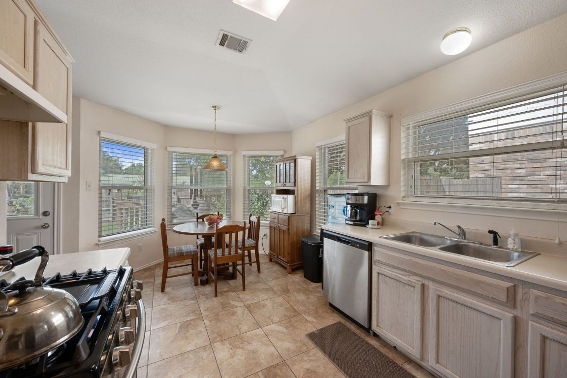 14505 Sandifer Street Austin, TX 78725 - Photo 9 of 28 a view of a kitchen and dining room