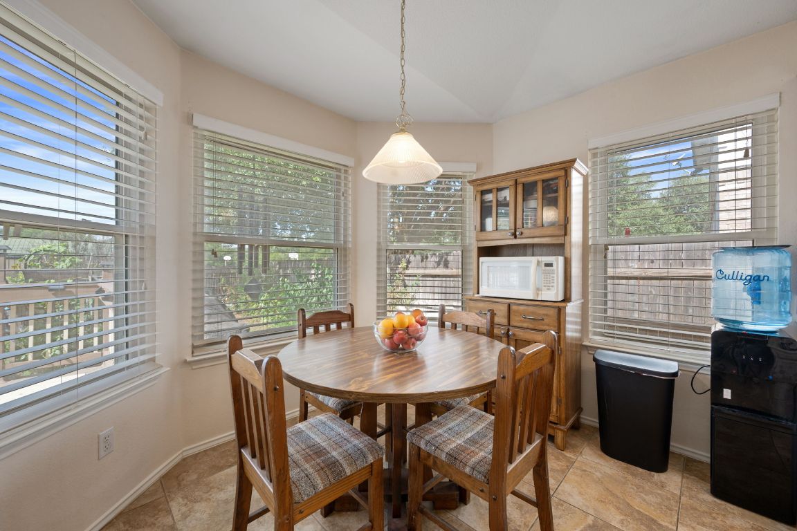 14505 Sandifer Street Austin, TX 78725 - Photo 10 of 28 a dining room with a table and chairs