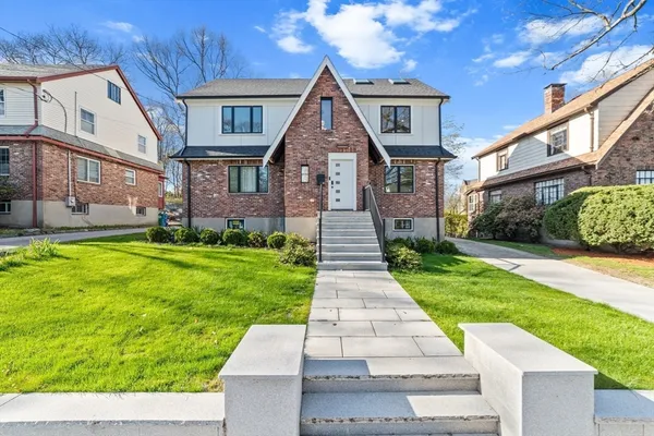 a front view of a house with a yard