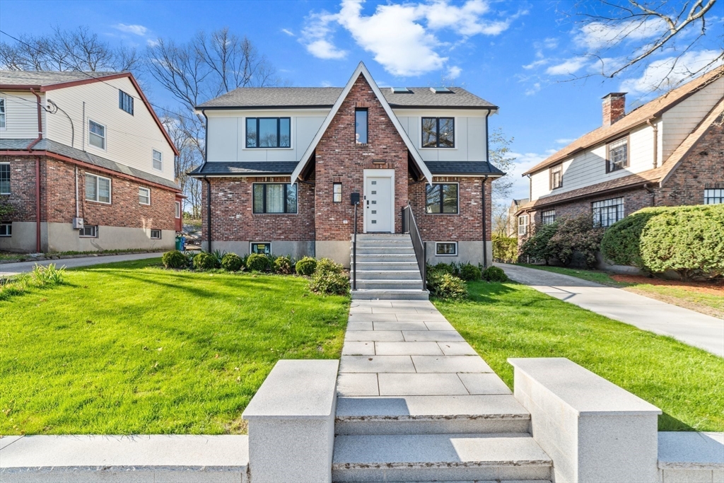 a front view of a house with a yard