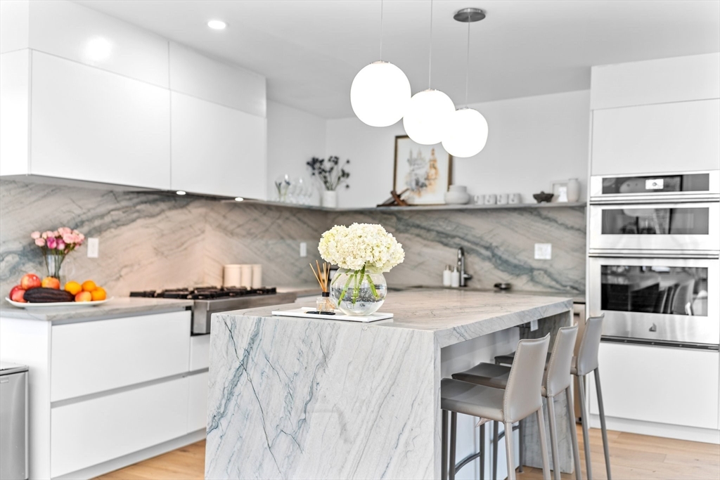 45 Rowena Road Newton, MA 02459 - Photo 12 of 42 a kitchen with a table and chairs in it