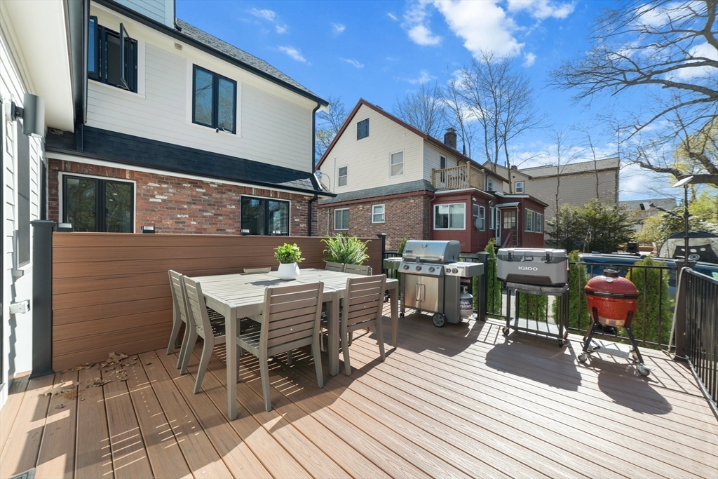 45 Rowena Road Newton, MA 02459 - Photo 15 of 42 a view of a patio with table and chairs and potted plants