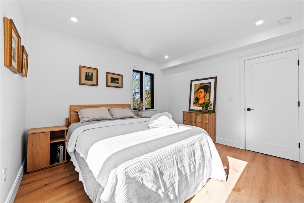 45 Rowena Road Newton, MA 02459 - Photo 18 of 42 a bed room with a bed and a painting on the wall