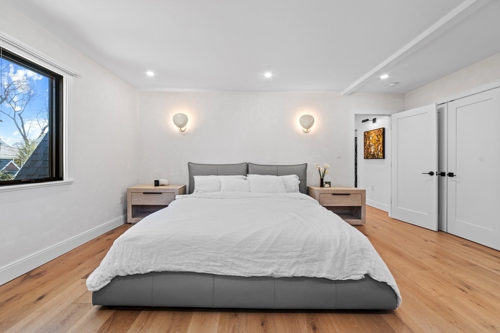 45 Rowena Road Newton, MA 02459 - Photo 19 of 42 a large bedroom with a bed and wooden floor