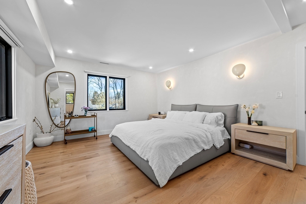 45 Rowena Road Newton, MA 02459 - Photo 20 of 42 a bedroom with a bed a mirror and a window