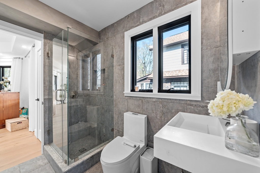 45 Rowena Road Newton, MA 02459 - Photo 28 of 42 a bathroom with a toilet sink and shower