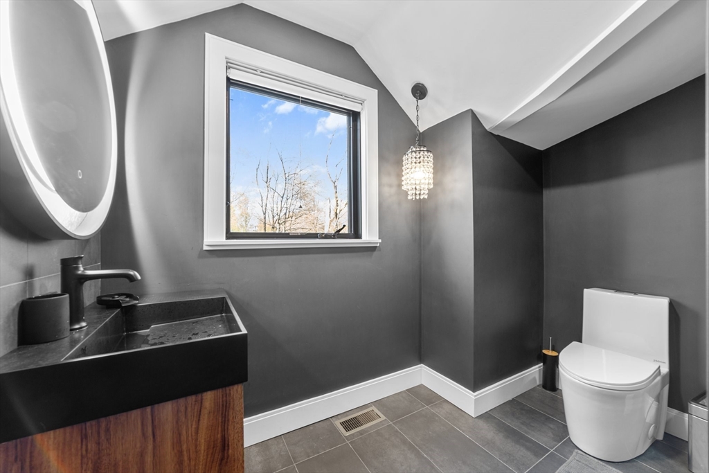 45 Rowena Road Newton, MA 02459 - Photo 29 of 42 a bathroom with a toilet sink and mirror