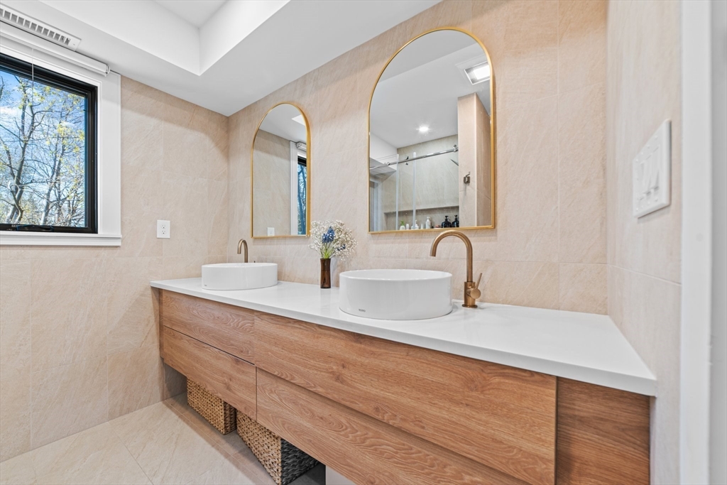 45 Rowena Road Newton, MA 02459 - Photo 33 of 42 a bathroom with double vanity sink and a mirror