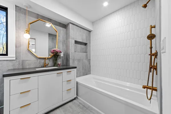 a bathroom with a bathtub and shower