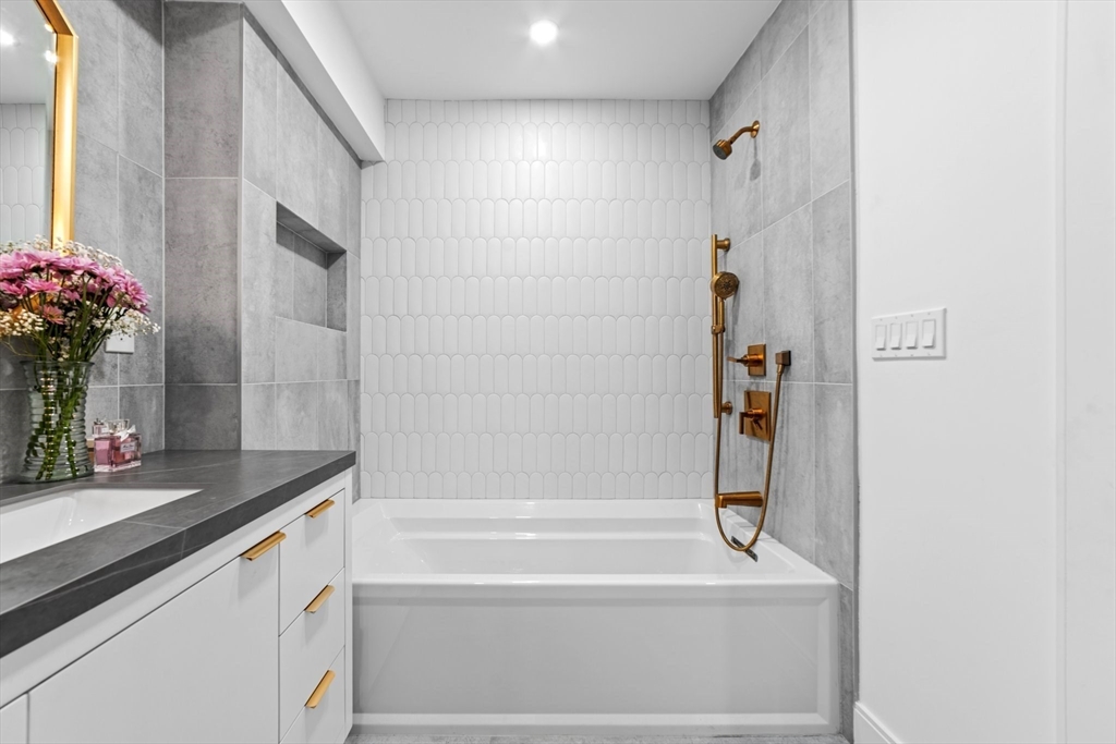 45 Rowena Road Newton, MA 02459 - Photo 35 of 42 a bathroom with a bathtub and shower