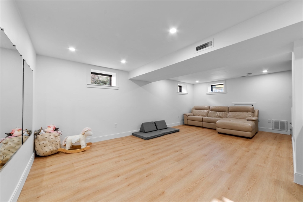 45 Rowena Road Newton, MA 02459 - Photo 38 of 42 a bedroom with furniture and a wooden floor