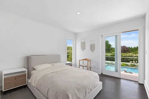 a bedroom with a large bed and a large window