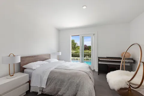 a bed room with a bed and a chair