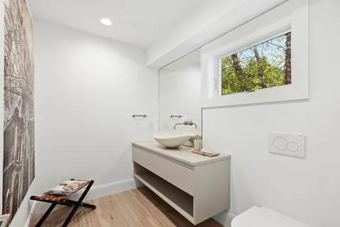 a bathroom with a sink toilet and window