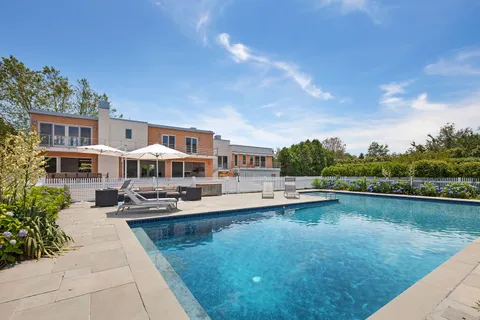 a view of a swimming pool with lounge chair