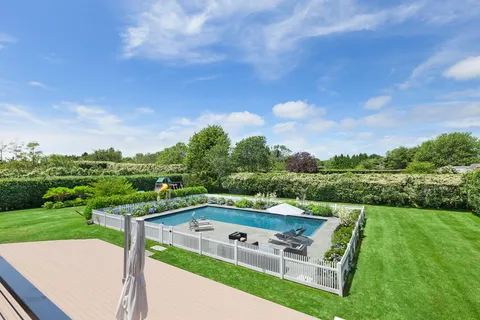 a view of a balcony with two chairs and a table
