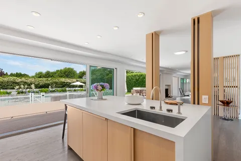 a kitchen with a sink and a large window