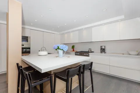 a view of a kitchen with a table and chairs