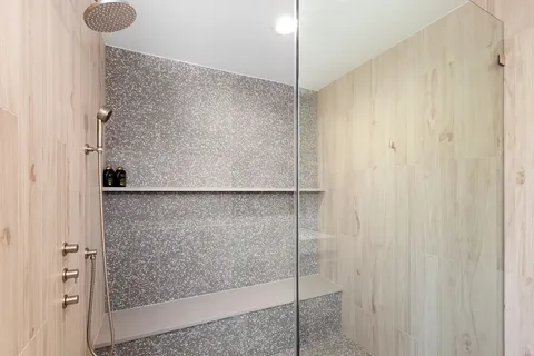 a bathroom with a glass shower door