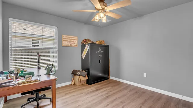 a view of a workspace with furniture and a window