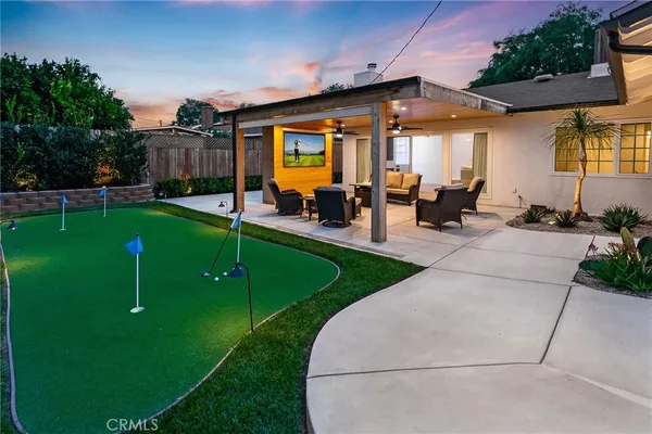 a view of a house with backyard porch and sitting area