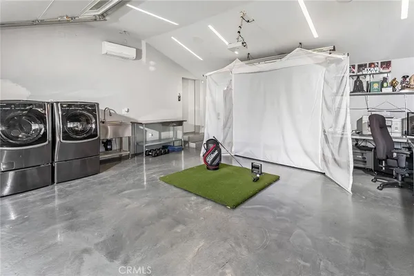 a living room with furniture and a gym machine