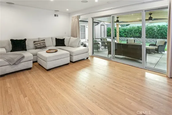 a living room with furniture and a floor to ceiling window